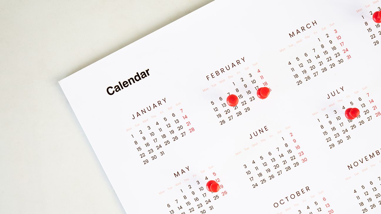 calendar of months with red pins