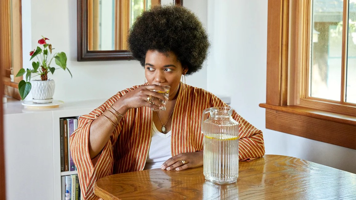 person drinking lemon water