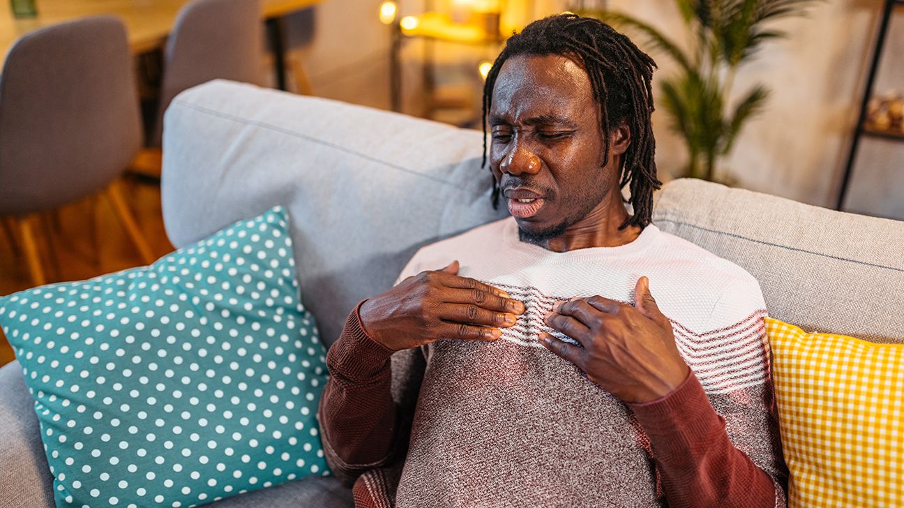 A man touching his chest.