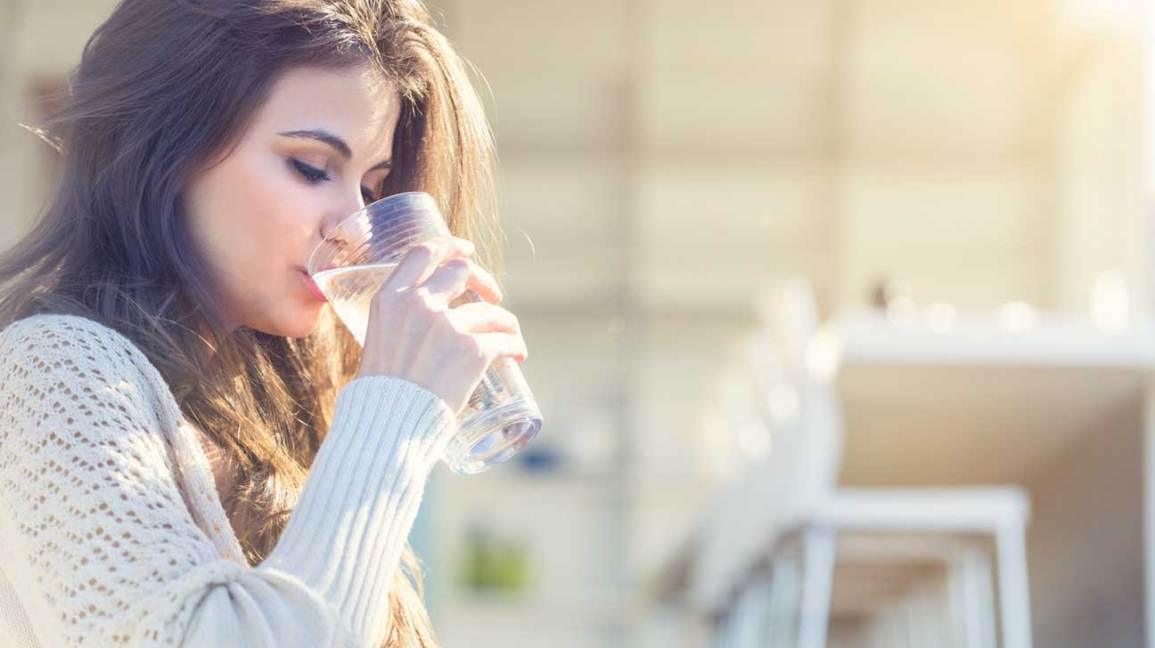 woman drinking a glass of water